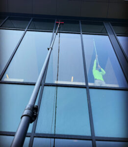 A window washer is cleaning the outside of a building.